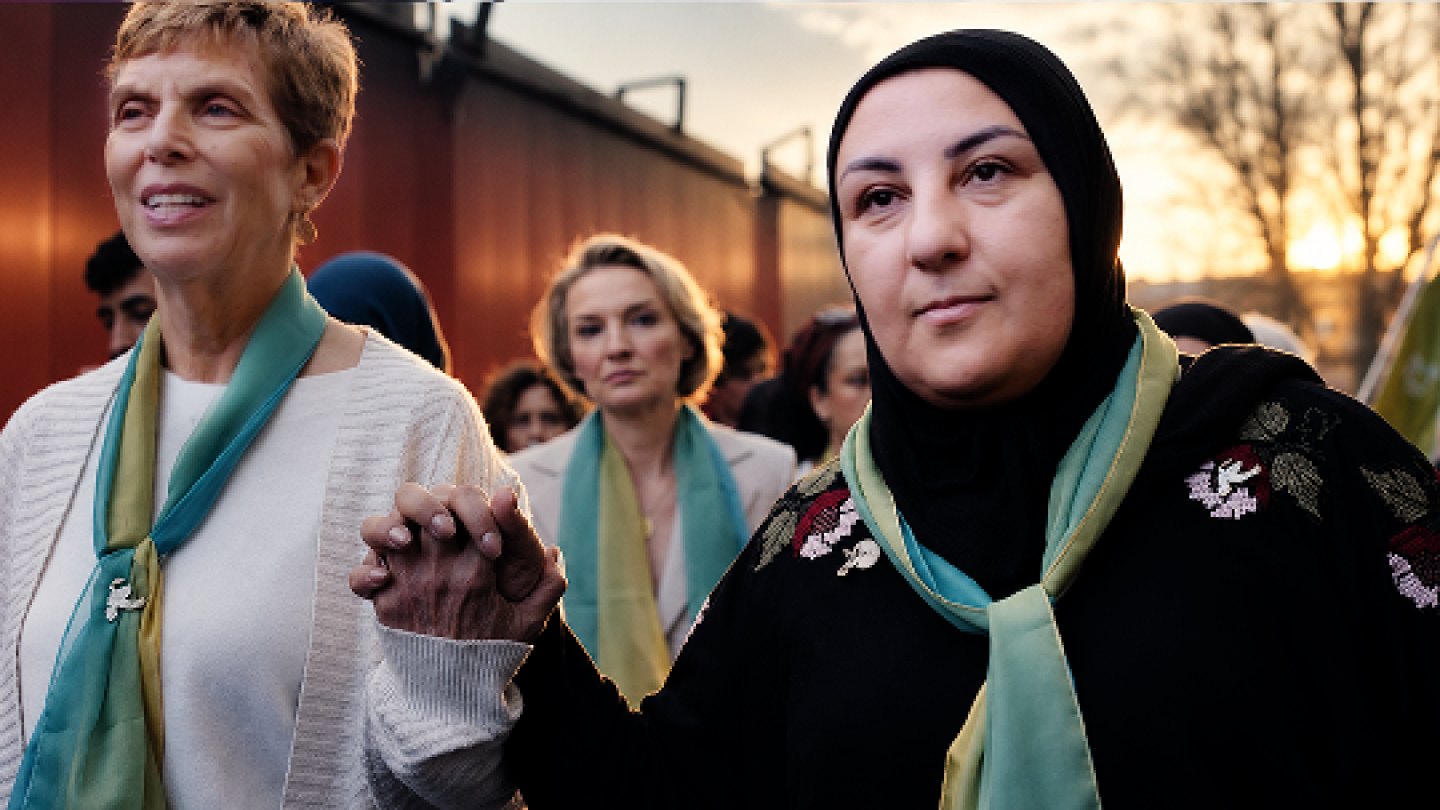 Women walking arm in arm, from Design Hierarchy’s social impact work
