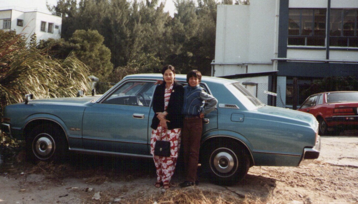 Ahmer Kalam as a boy with his mother beside a blue car
